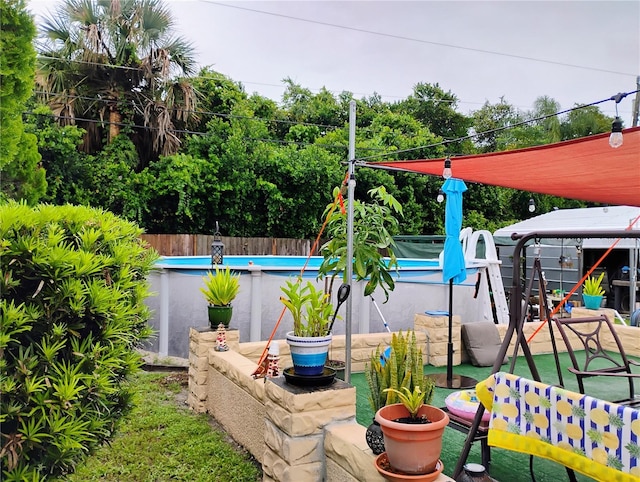 view of yard with a fenced in pool