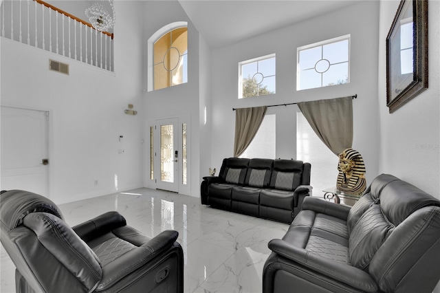 living room featuring a towering ceiling and french doors