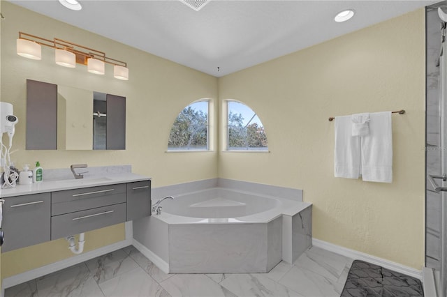 bathroom with vanity and separate shower and tub