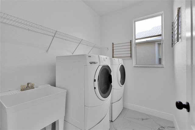 washroom with sink and washer and clothes dryer