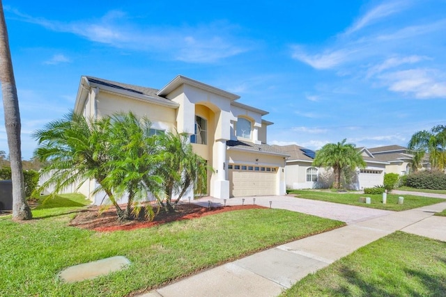 mediterranean / spanish house with a front yard and a garage