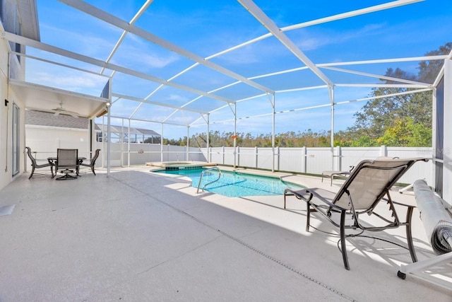 view of pool with a patio area and glass enclosure