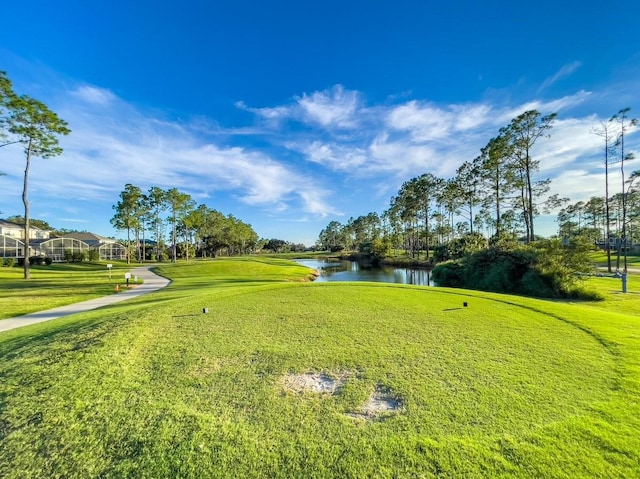 view of home's community featuring a water view and a lawn