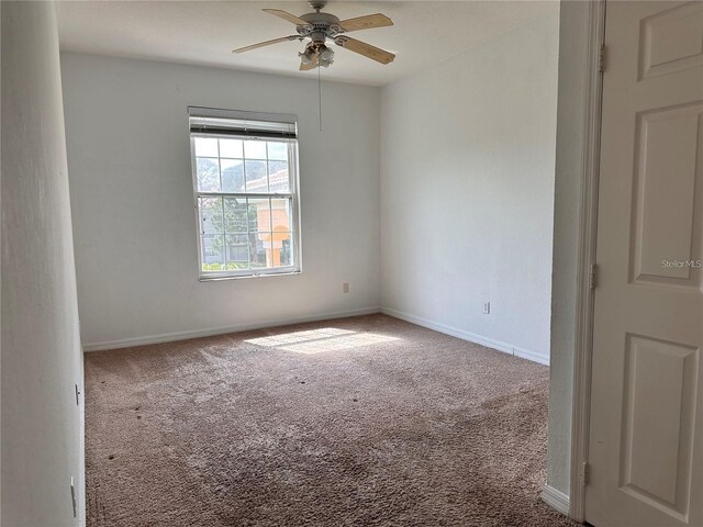 unfurnished room with carpet and ceiling fan