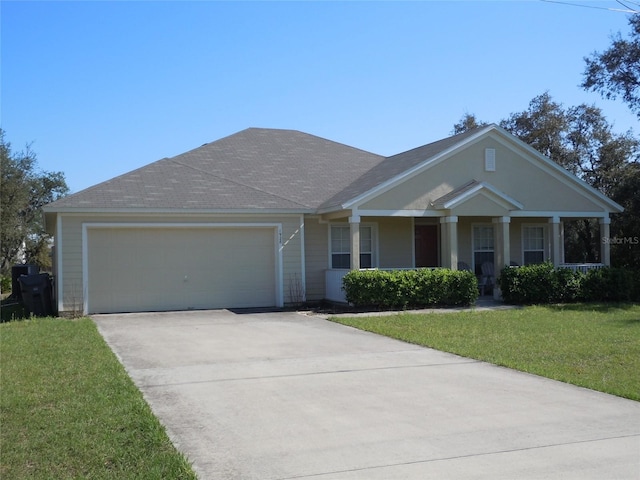 view of front of property with covered porch, a front yard, and a garage