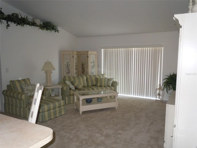 living room with lofted ceiling and carpet flooring