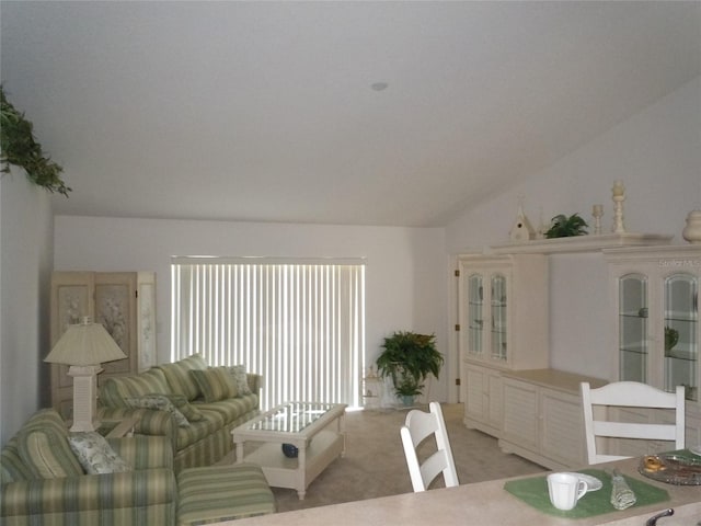 carpeted living room with lofted ceiling