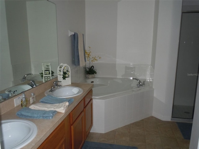 bathroom with tile patterned floors, vanity, and separate shower and tub