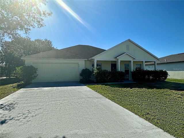 view of front of home featuring a front lawn, an attached garage, and driveway