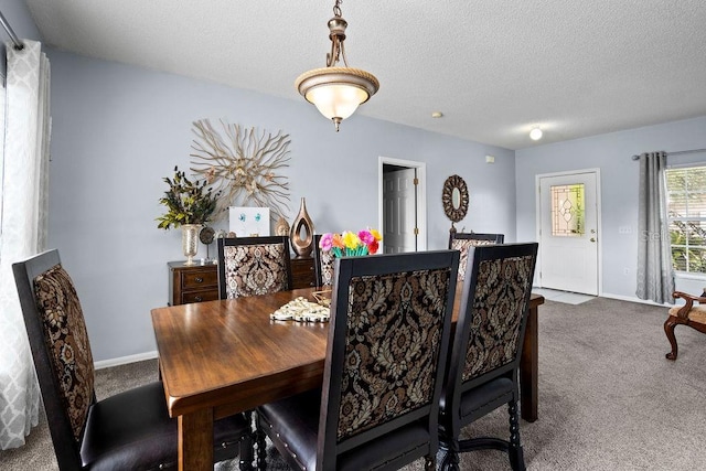 dining space with carpet flooring, baseboards, and a textured ceiling