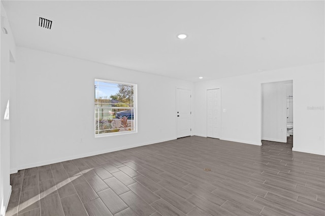 spare room with dark wood-type flooring