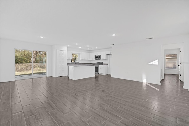 unfurnished living room featuring dark hardwood / wood-style floors