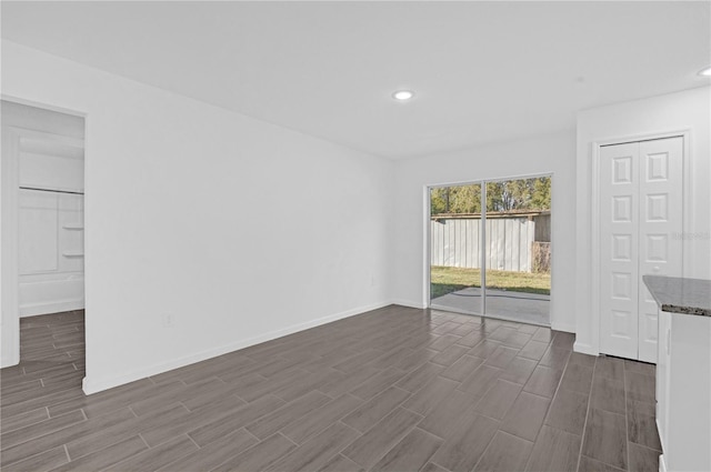 unfurnished living room featuring dark hardwood / wood-style flooring