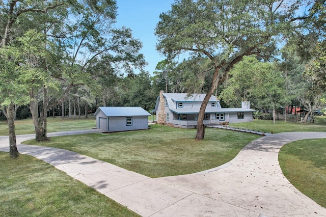 view of front of house with a front yard and an outbuilding