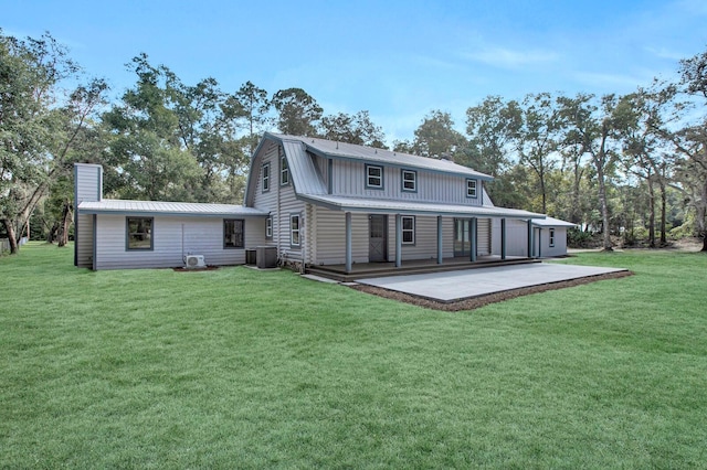 rear view of house with a lawn and central air condition unit