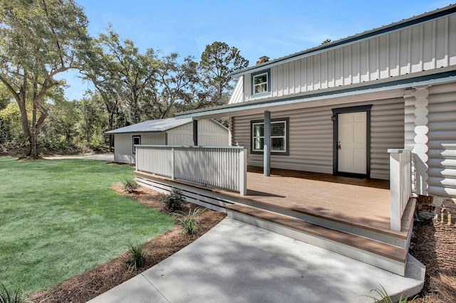 entrance to property with a lawn and a wooden deck