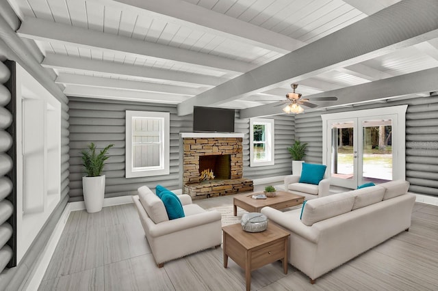 living room with french doors, beamed ceiling, a fireplace, and ceiling fan