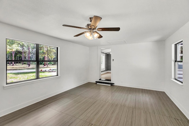 empty room featuring a textured ceiling and ceiling fan