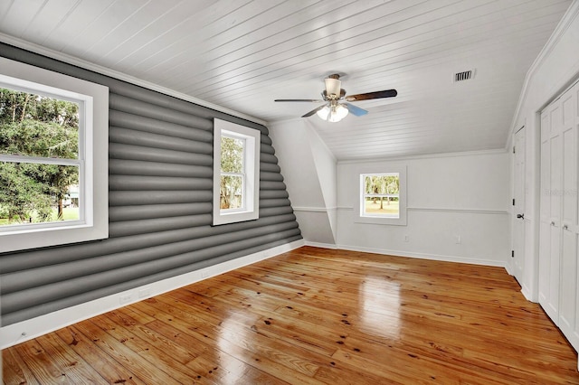 additional living space featuring ceiling fan, light wood-type flooring, plenty of natural light, and vaulted ceiling