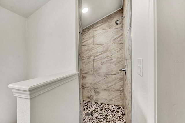 bathroom with a tile shower