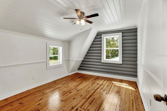 additional living space with vaulted ceiling, hardwood / wood-style floors, and a wealth of natural light