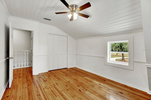 unfurnished bedroom with ceiling fan, wooden ceiling, light wood-type flooring, crown molding, and vaulted ceiling