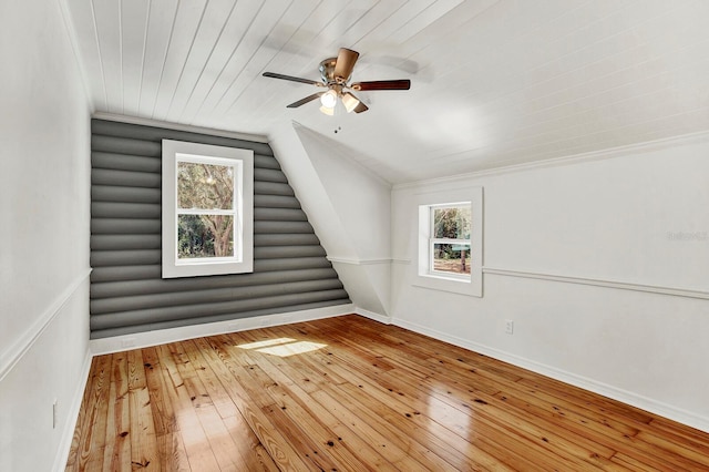 additional living space with wood-type flooring, plenty of natural light, vaulted ceiling, and ceiling fan