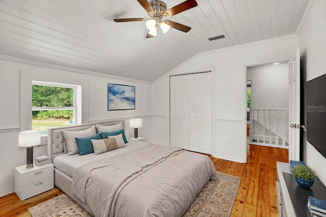 bedroom featuring light hardwood / wood-style floors, vaulted ceiling, a closet, wooden ceiling, and ceiling fan