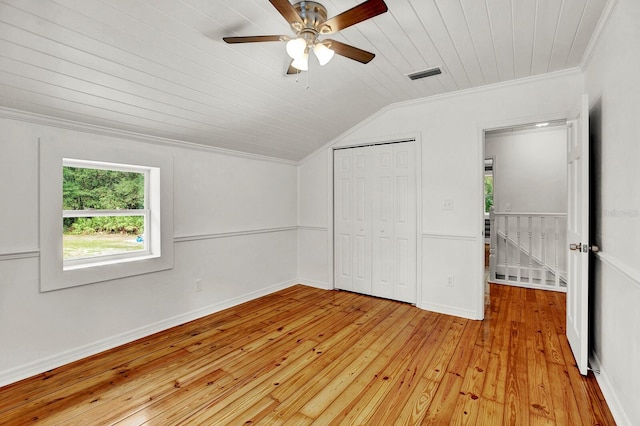 unfurnished bedroom featuring ceiling fan, wood ceiling, light hardwood / wood-style floors, crown molding, and vaulted ceiling