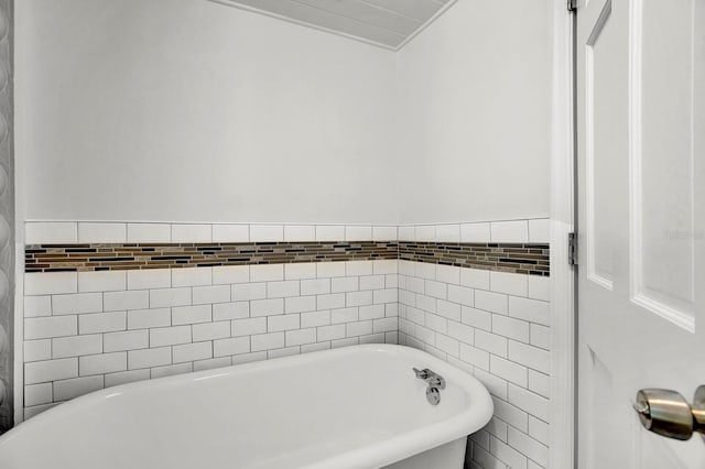 bathroom with tile walls and a washtub