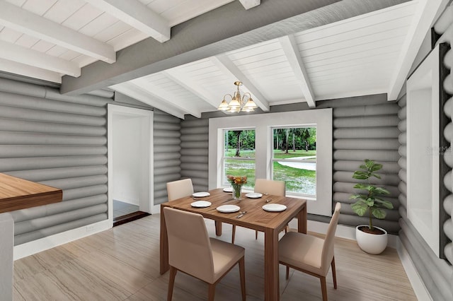 dining room featuring an inviting chandelier, light hardwood / wood-style floors, rustic walls, and vaulted ceiling with beams