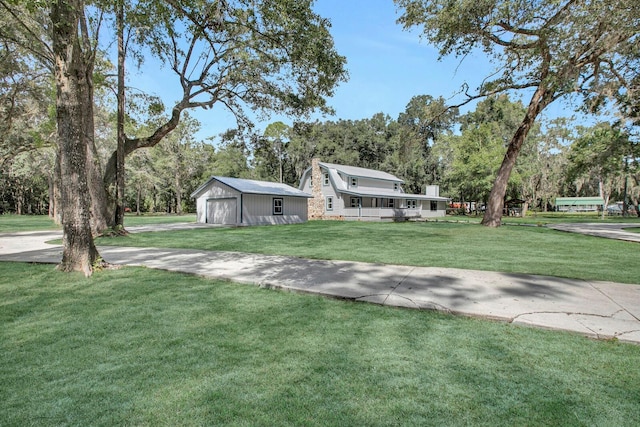 view of front of house with an outbuilding and a front lawn