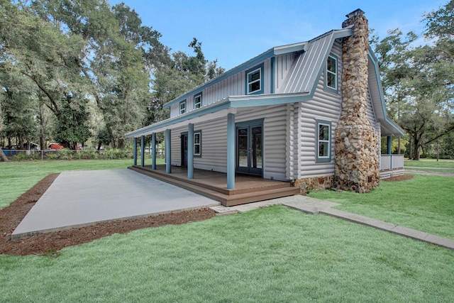 rear view of house featuring a lawn