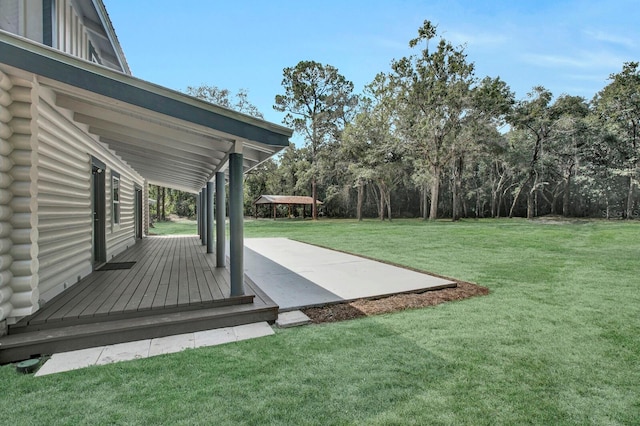 view of yard featuring a patio area and a deck