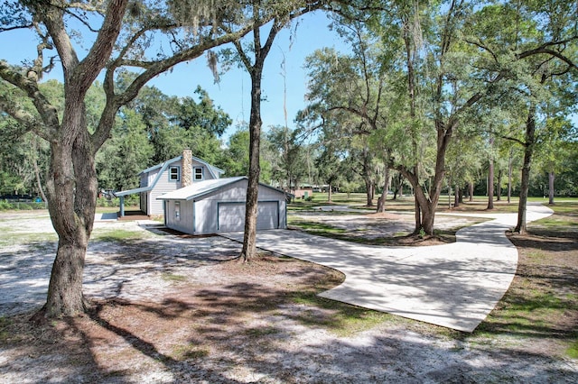 view of side of home featuring an outdoor structure and a garage