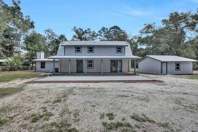 view of front of property featuring an outdoor structure