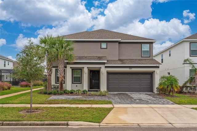 front facade featuring a garage and a front yard