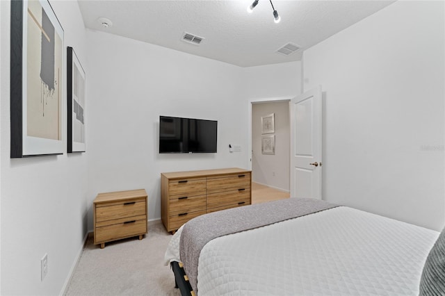 carpeted bedroom with a textured ceiling