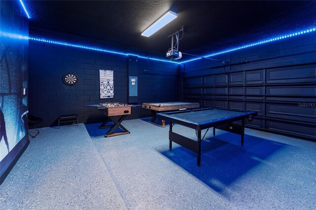 game room with a textured ceiling