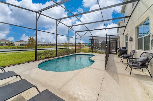 view of pool with a patio and glass enclosure