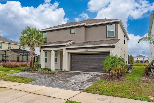 view of front of property with a front yard and a garage