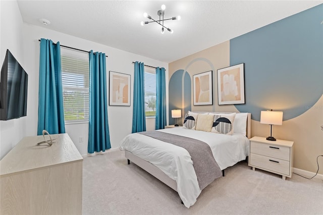 bedroom with a textured ceiling and light carpet