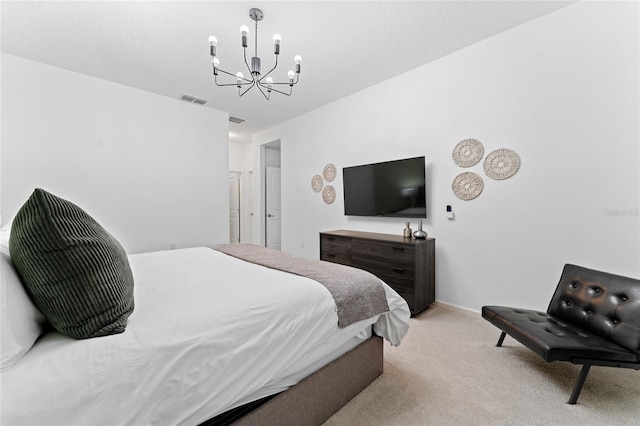 carpeted bedroom featuring an inviting chandelier