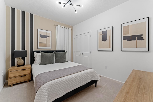 carpeted bedroom featuring a closet and a textured ceiling