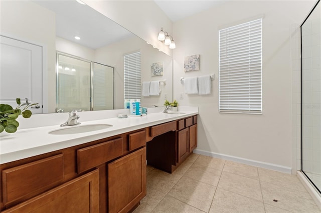 bathroom featuring tile patterned flooring, an enclosed shower, and vanity