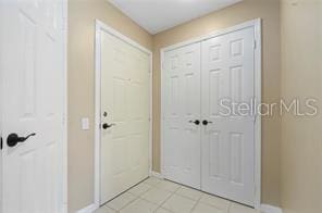 doorway with light tile patterned floors