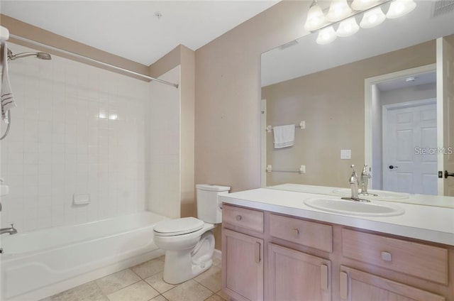 full bathroom with tile patterned floors, tiled shower / bath combo, vanity, and toilet