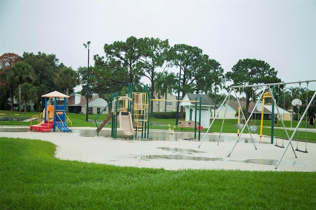 view of jungle gym featuring a lawn