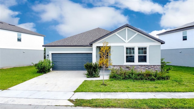 view of front of property with a front yard and a garage