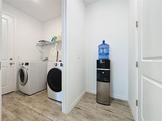 laundry area featuring light wood-type flooring and washer / clothes dryer